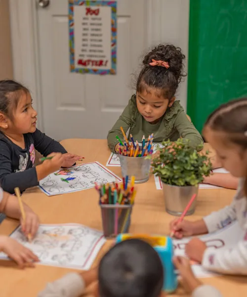 Children engaged in hands-on bilingual learning at Little Thinkers ABC