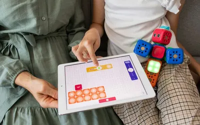 Child playing and learning with digital and hands-on technology