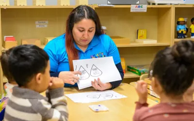 Little Thinkers ABC teacher leading a small group lesson at a classroom table